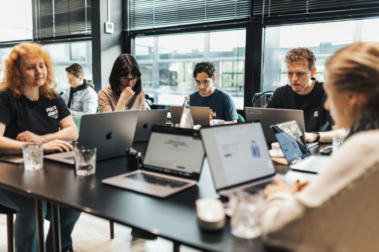 Focused team engaged in discussion and planning at a modern office setting.